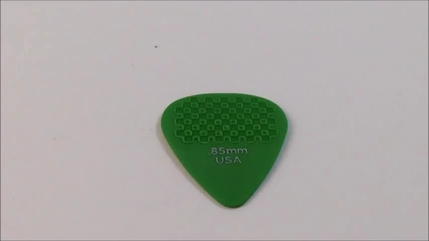 A hand holding a DuraGrip pick, showcasing its textured surface.