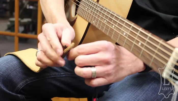 Push the ends through the open end of the strap.