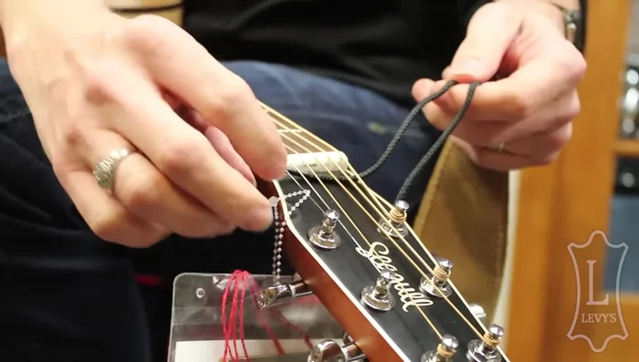 Loop the shoelace around the headstock.