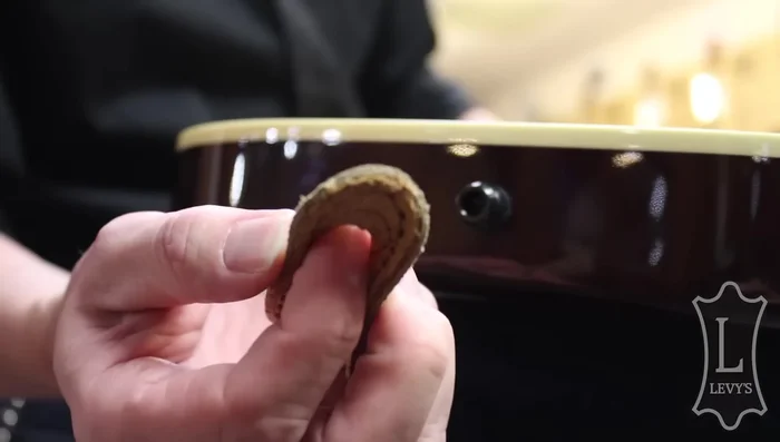 Widen the hole on the strap using your finger.