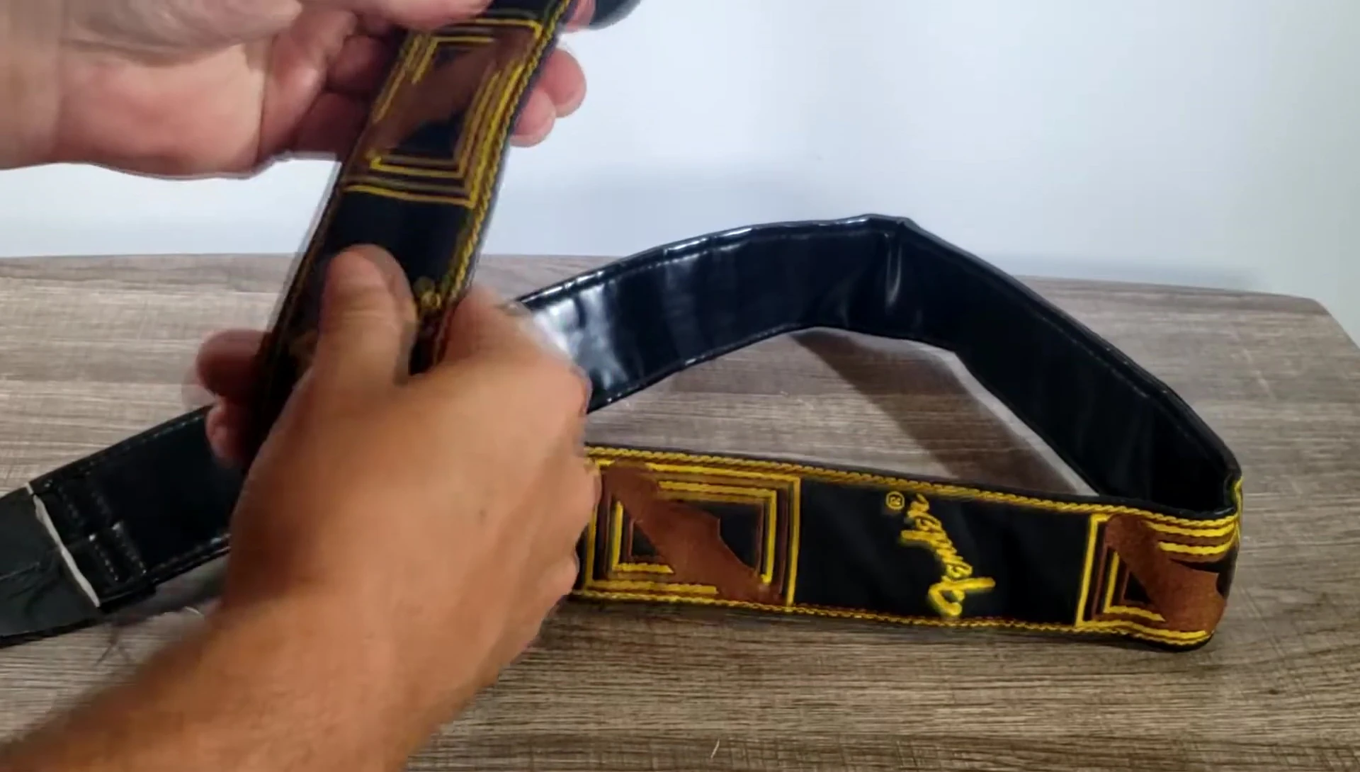 Detailed view of the woven Fender Stratocaster headstocks and logo on the strap.
