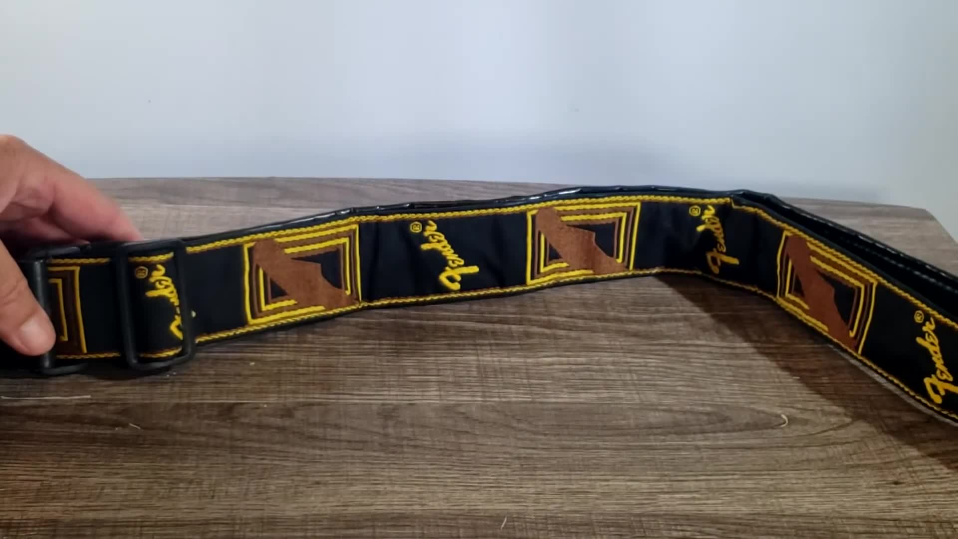 Close-up shot of the Fender monogrammed strap showing the color and pattern.