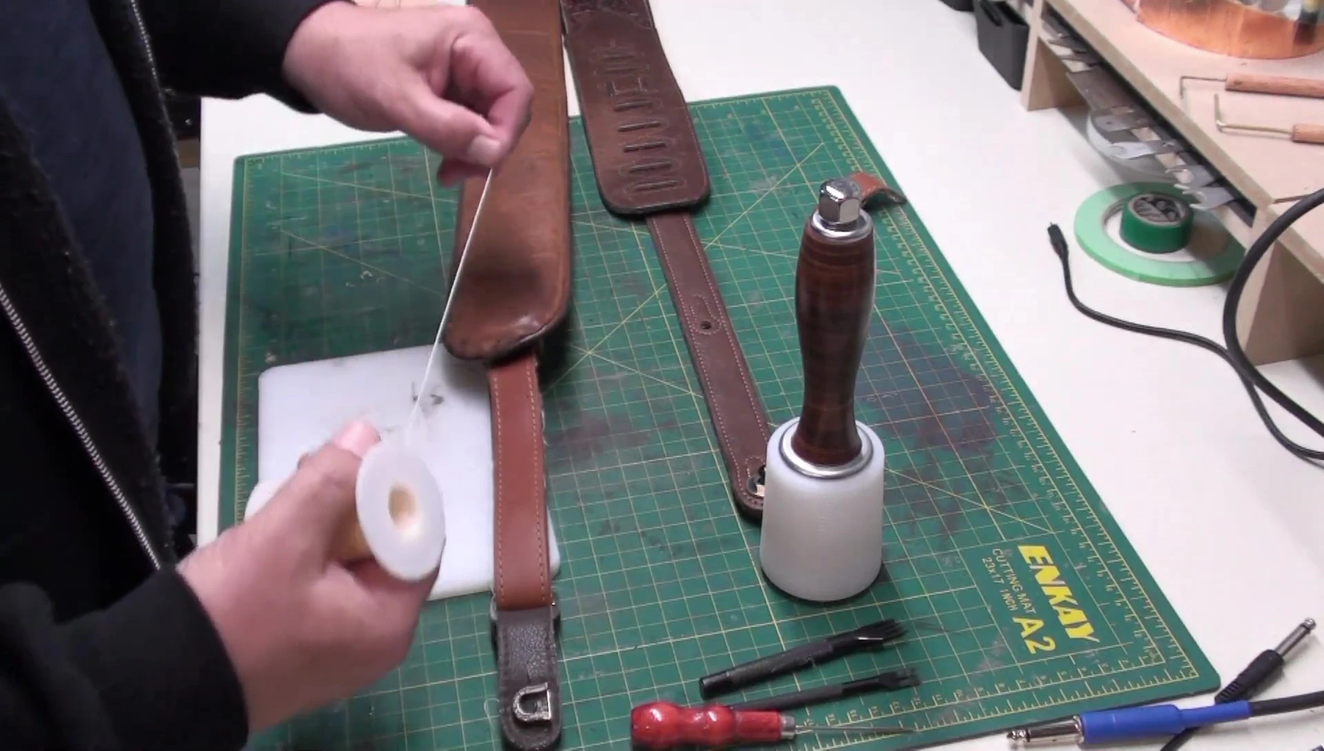 Preparing the needles and thread for saddle stitching.