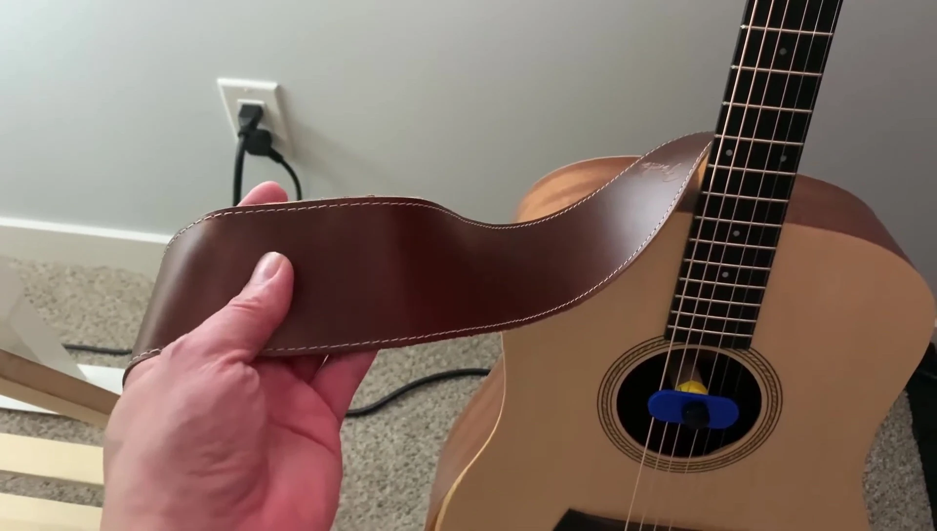 The reviewer wearing the guitar strap