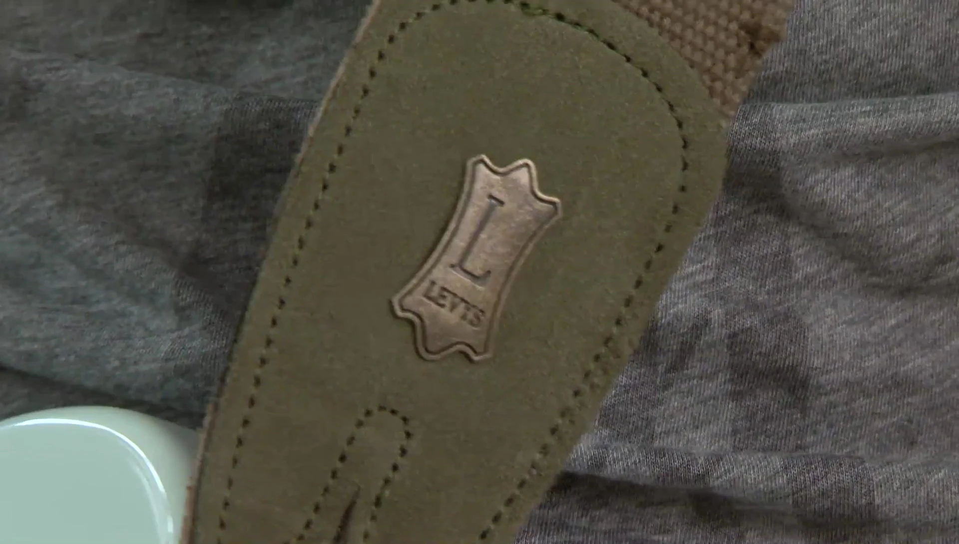 The Distressed Green Strap, showcasing its cotton and suede construction.