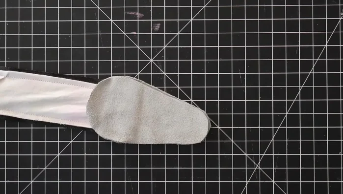 Sew the two smaller leather pieces together with the end of the strap sandwiched between them (using double-sided tape to hold).