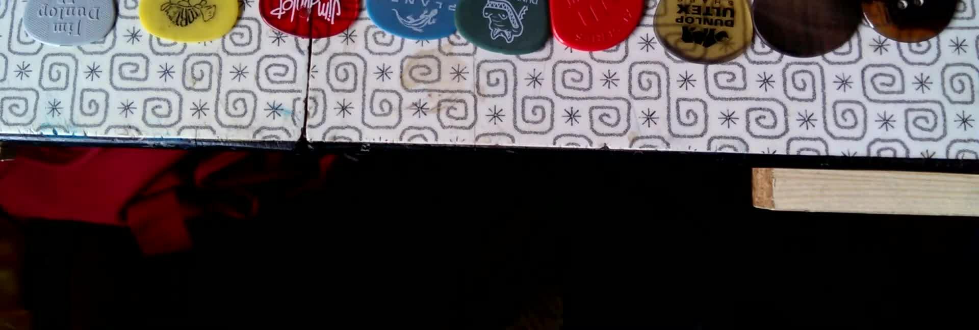 Close-up of various guitar picks laid out.