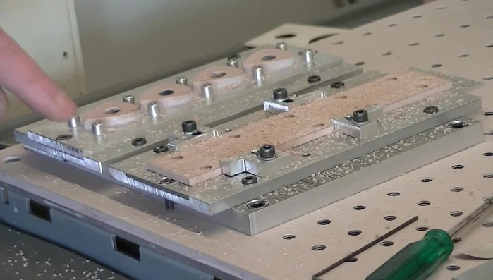 Flip the wood over, aligning it with the jig using the alignment holes and securing it with screws.