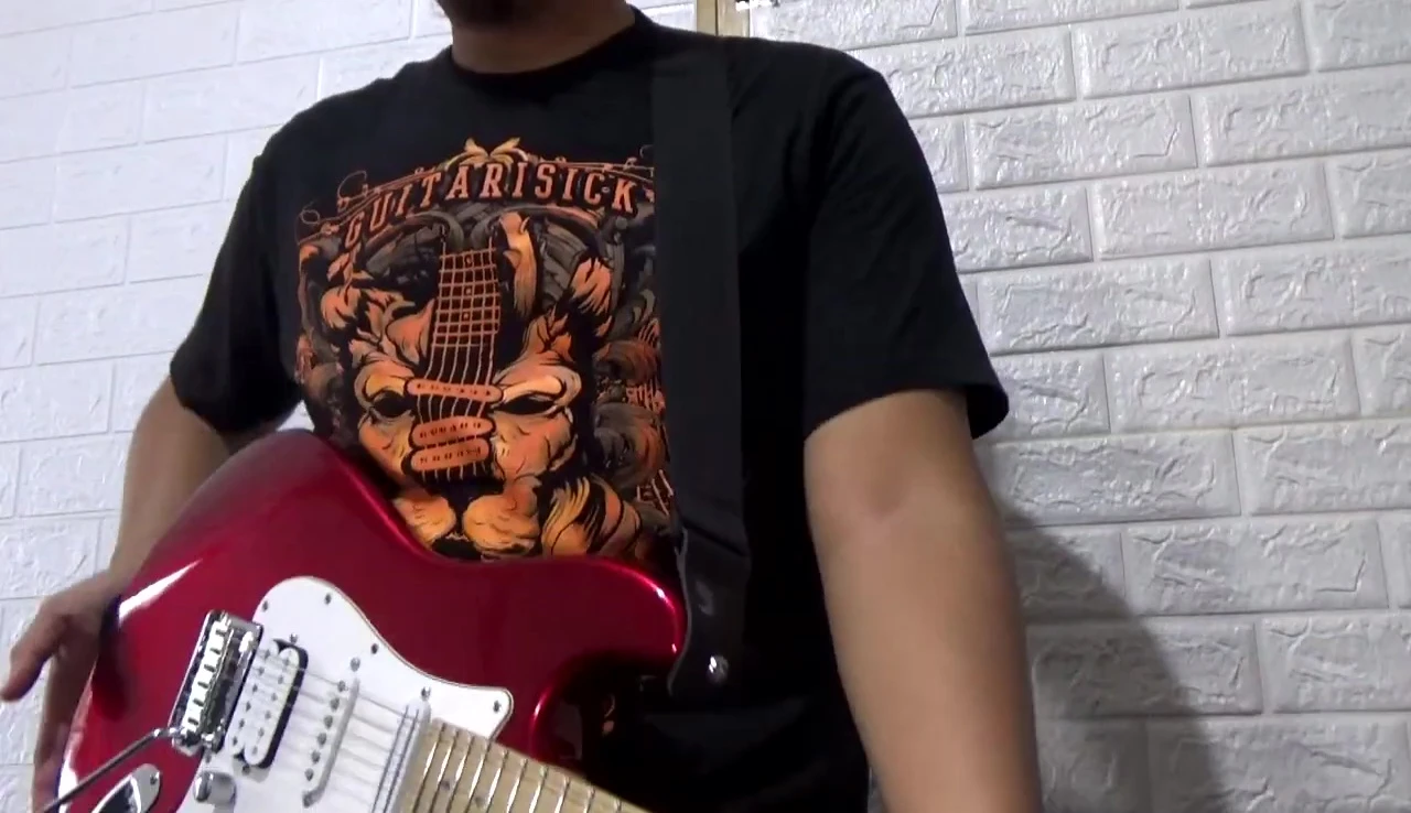 The guitarist wearing the strap during a performance.