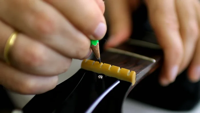 Reinstall the strings, avoiding winding them around the peg too many times.