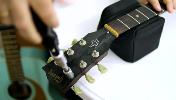 Remove the old tuning machines.