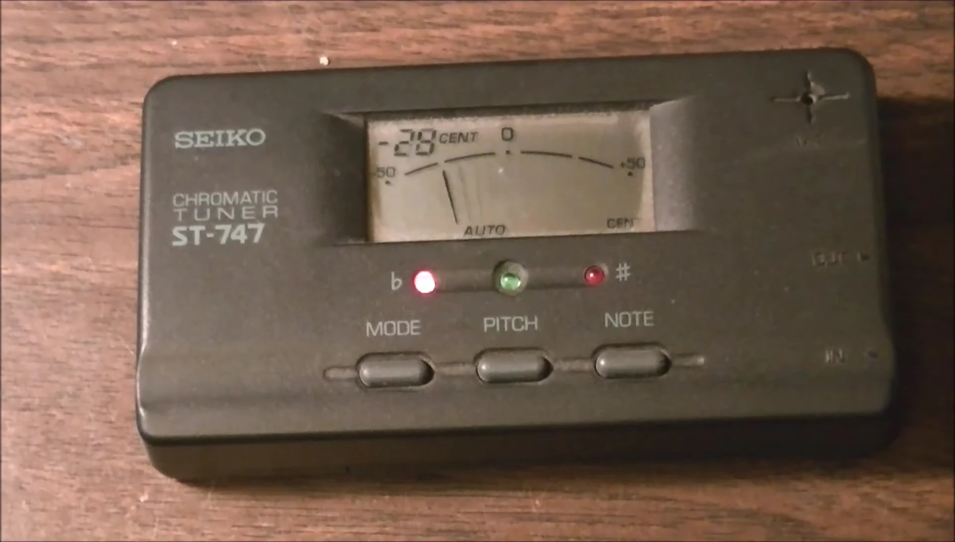 Close-up of the tuner showing the pass-through input/output jacks.