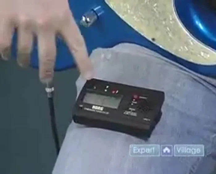 If the needle is below the center, tighten the tuning peg. If it's above, loosen it.