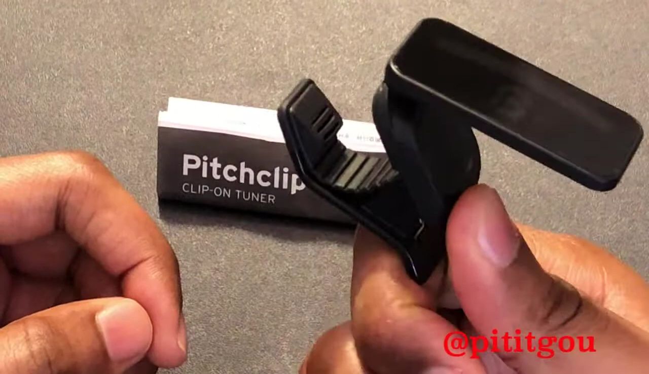 Close-up of the Korg Pitchclip 2 being opened, showcasing its sturdy construction.