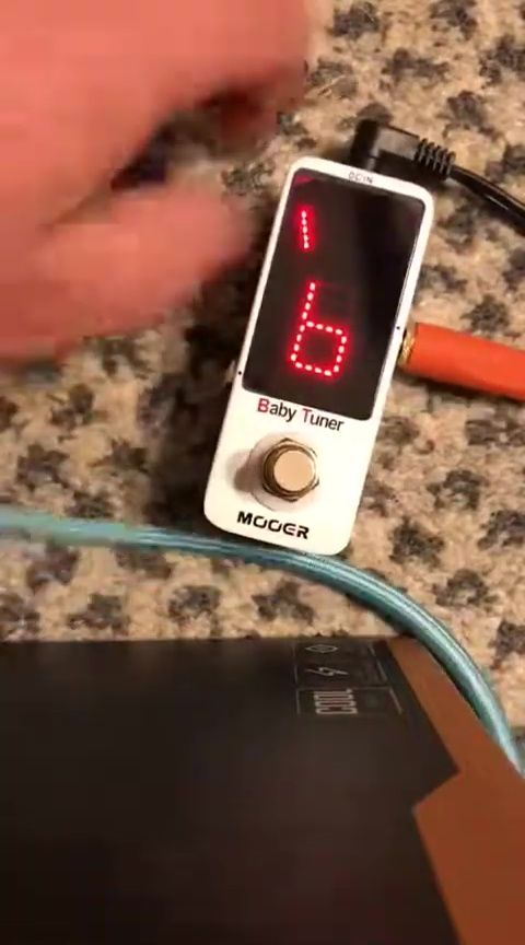 Showing the back of the tuner, highlighting the velcro attachment points.