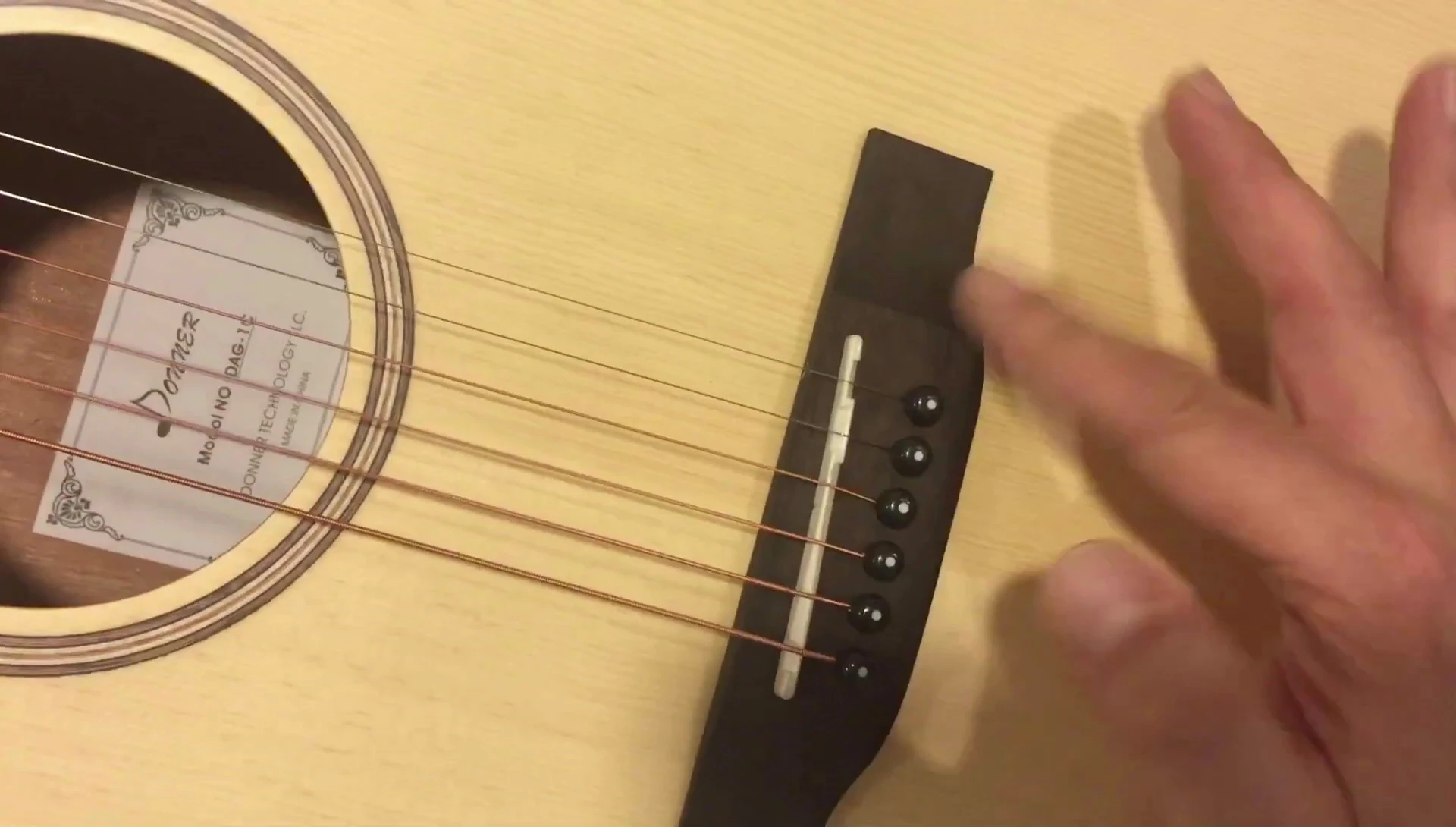 Close-up shot of the guitar bridge.