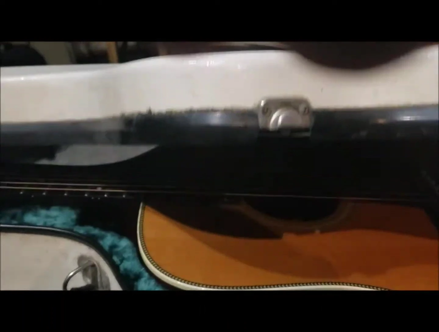 The speaker opening the Calton case to reveal the guitar inside