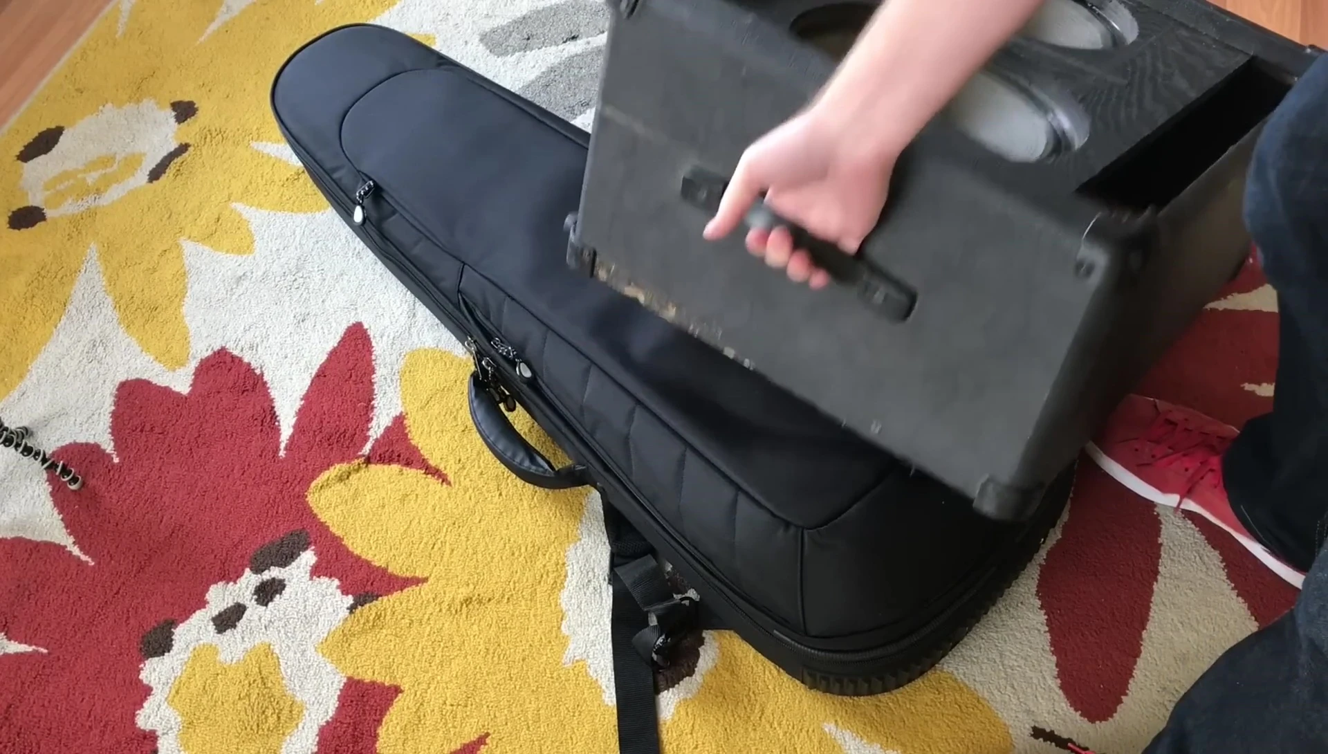 The tester inspecting the case after the cabinet drop, showing no visible damage.
