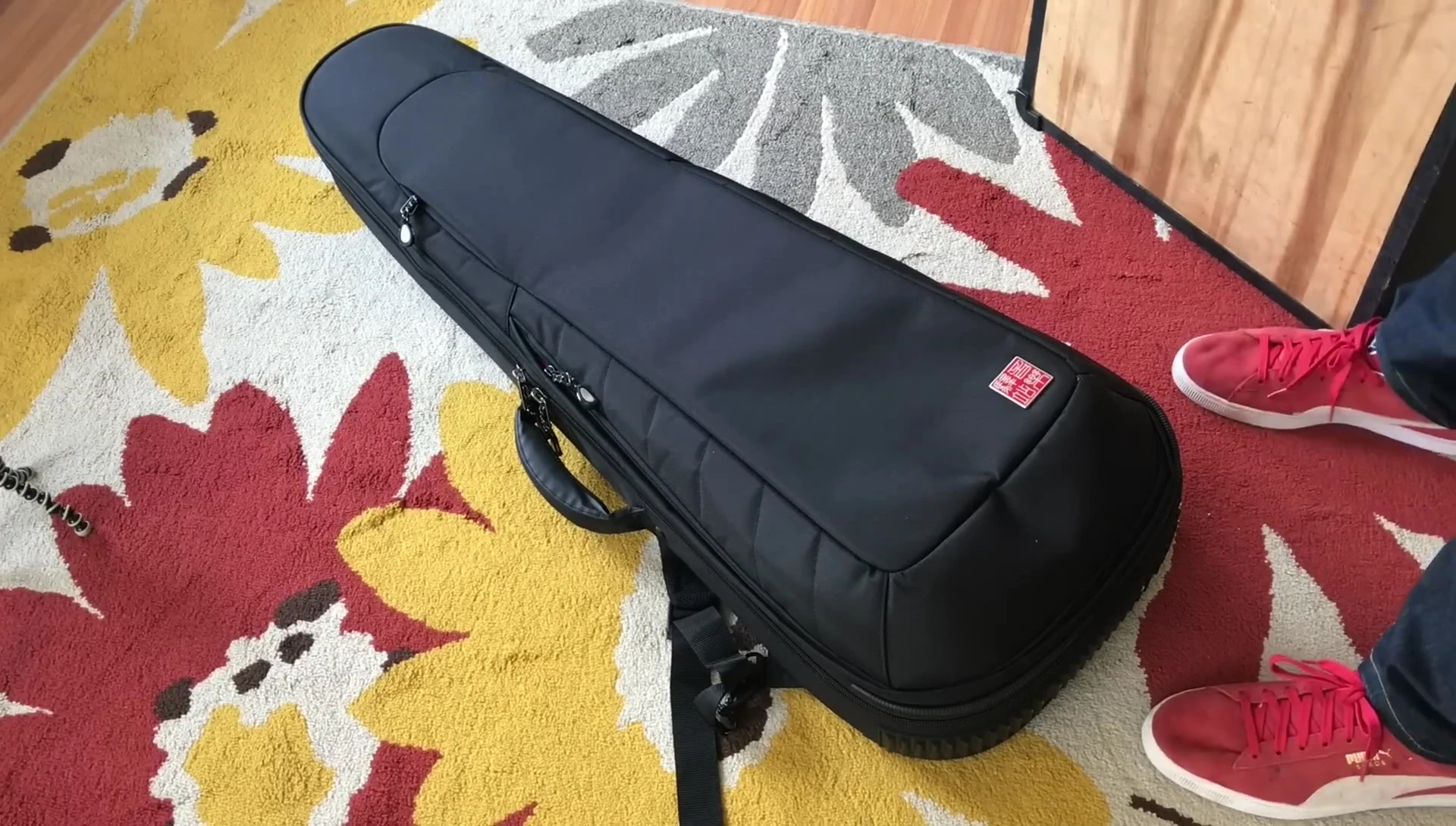 The large 2x12 speaker cabinet positioned above the guitar case.