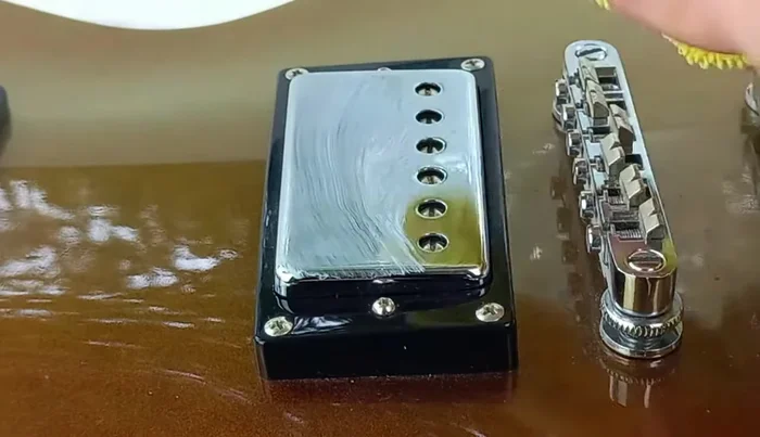 Apply a small amount of guitar polish, then polish off with a clean microfiber cloth.