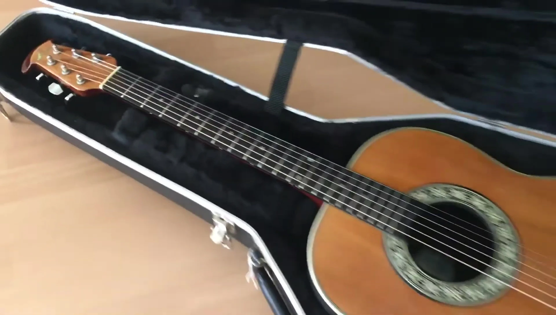 The guitar fitting snugly inside the case.