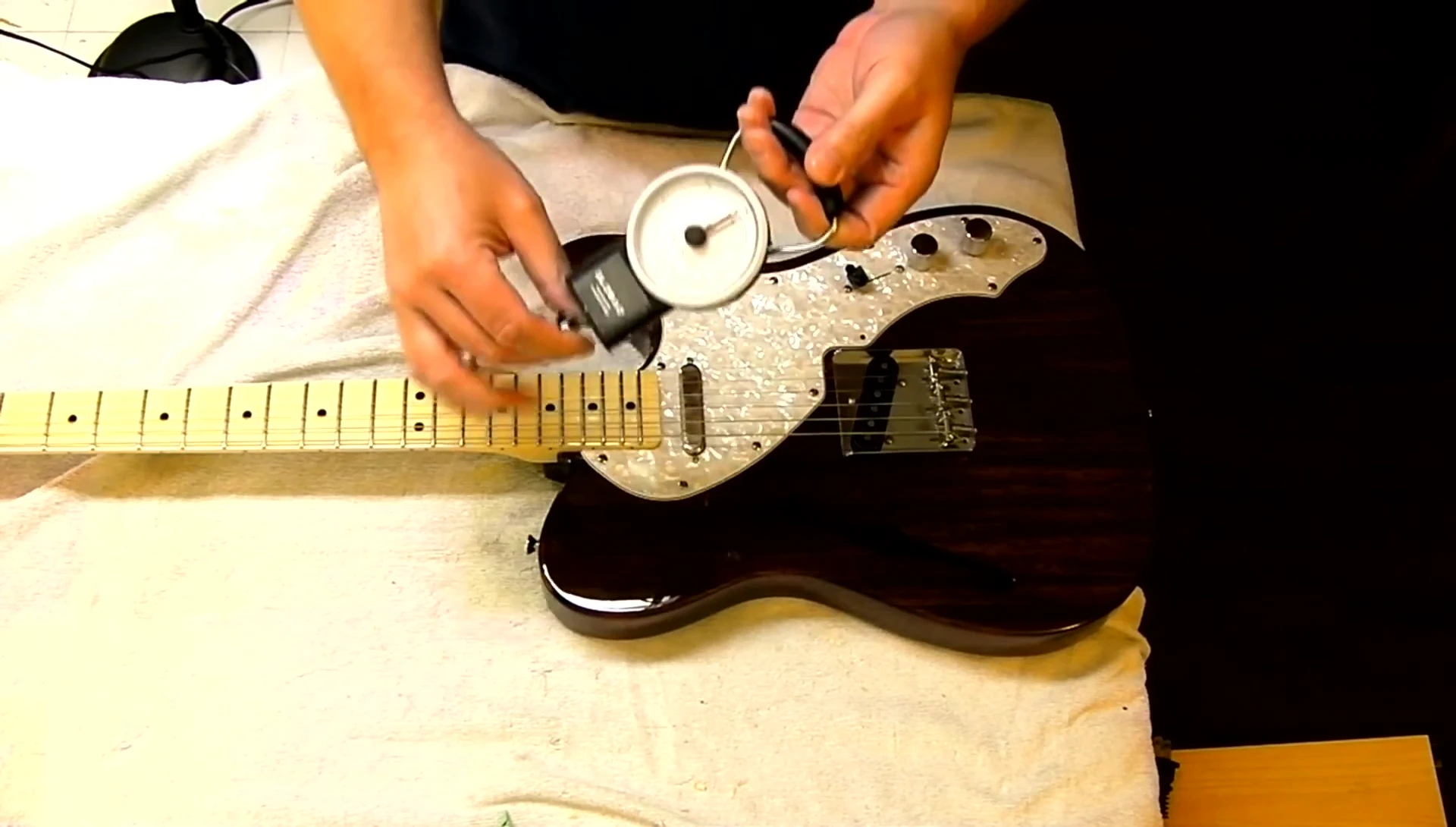 The guitarist setting up the scale for the bending test.