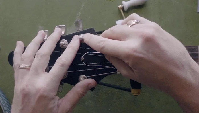 Check the tuning post for burrs using your fingernail.