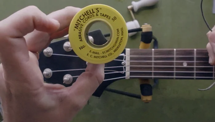 Use Mitchell's Abrasive Cord (a gauge appropriate for the string size) to floss the tuning post.