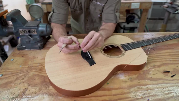 Gradually curve the slot to create a larger break angle. Be cautious not to cut into the saddle.