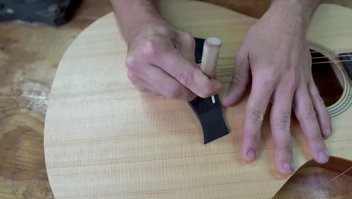 Gradually curve the slot to create a larger break angle. Be cautious not to cut into the saddle.