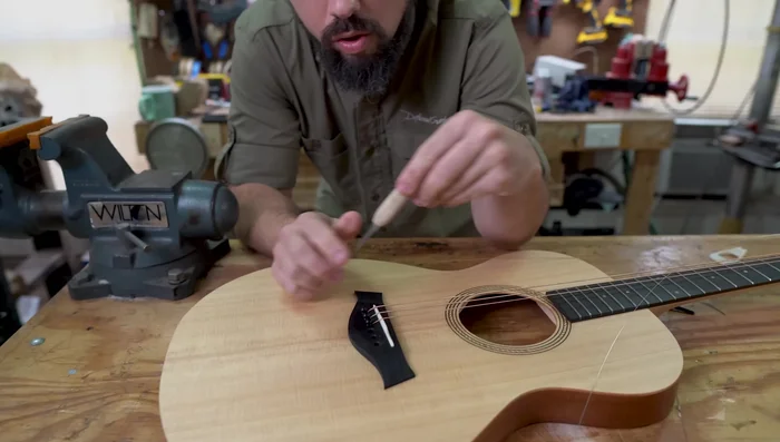 Gradually curve the slot to create a larger break angle. Be cautious not to cut into the saddle.