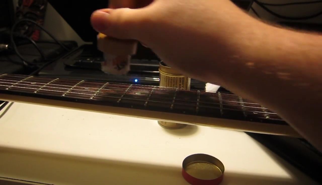 Reviewer demonstrating the difficulty of applying lubricant to the fretboard with the stick applicator.
