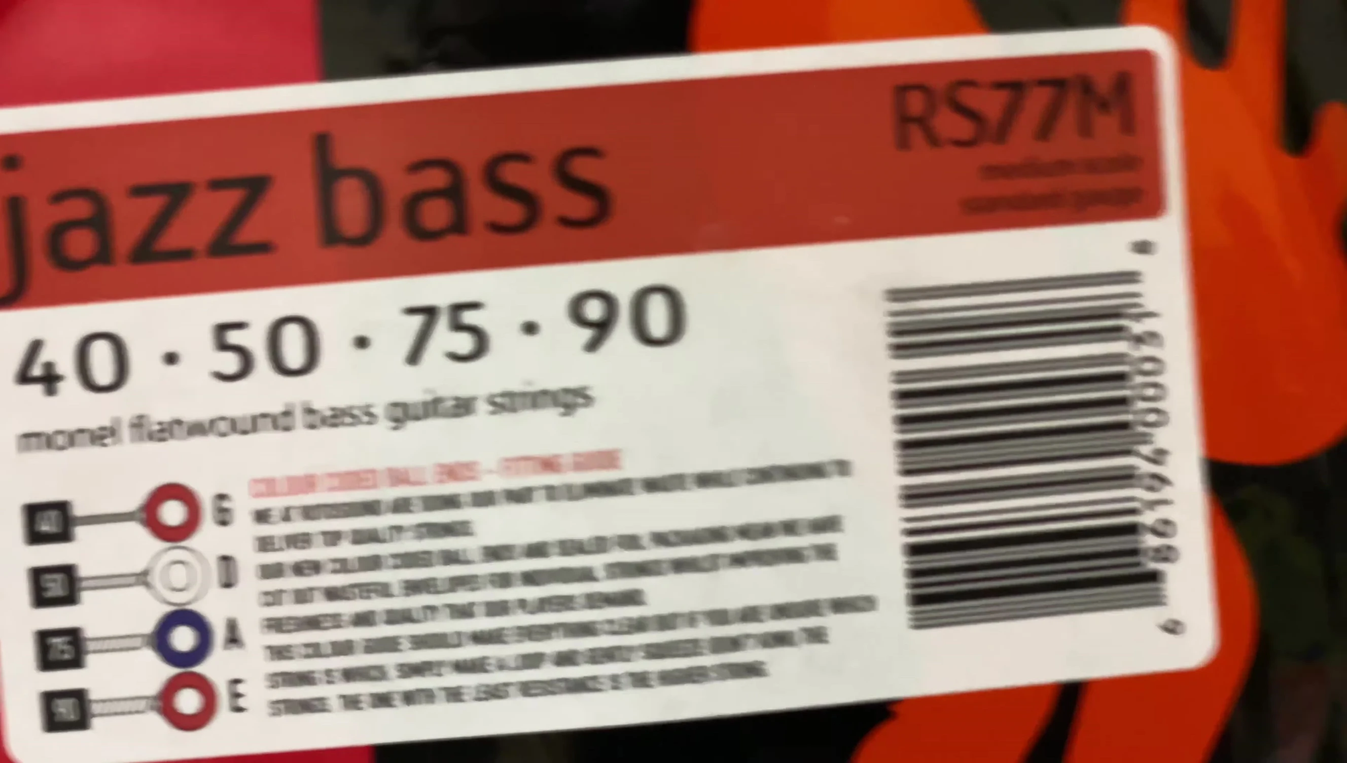 Close-up of the Rotosound RS77M strings being installed on the Schecter Banshee bass.
