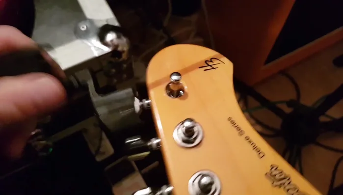 Use a string winder to smoothly turn the tuning peg.