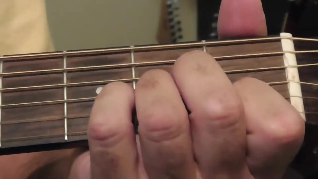Close up of the reviewer's hands fingerpicking.