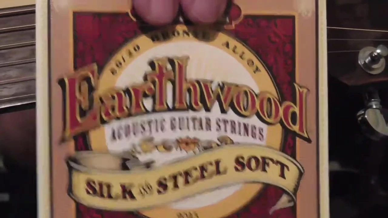 Close-up of the Ernie Ball Earthwood Silk & Steel strings packaging.