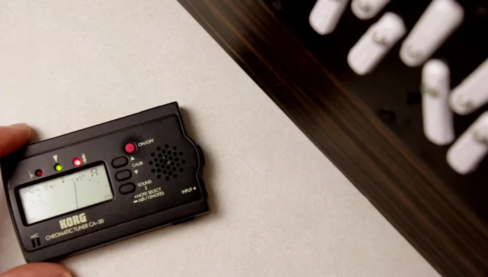 Observe the tuner reading. If the instrument is sharp, calibrate the tuner slightly higher; if flat, calibrate lower.