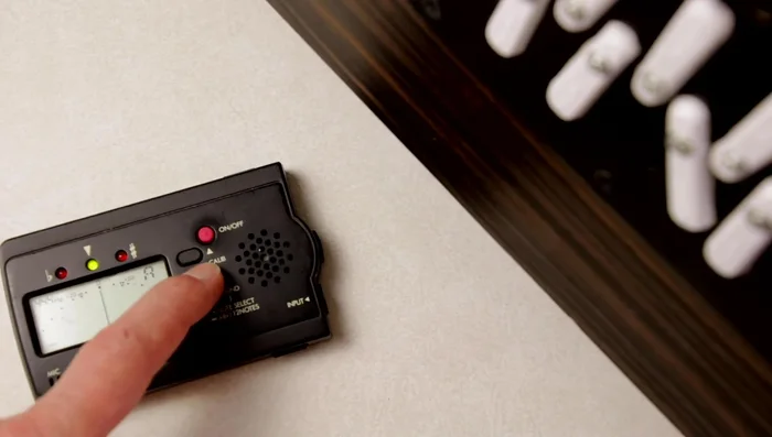 Adjust the tuner's calibration until the reference note displays accurately on the tuner.