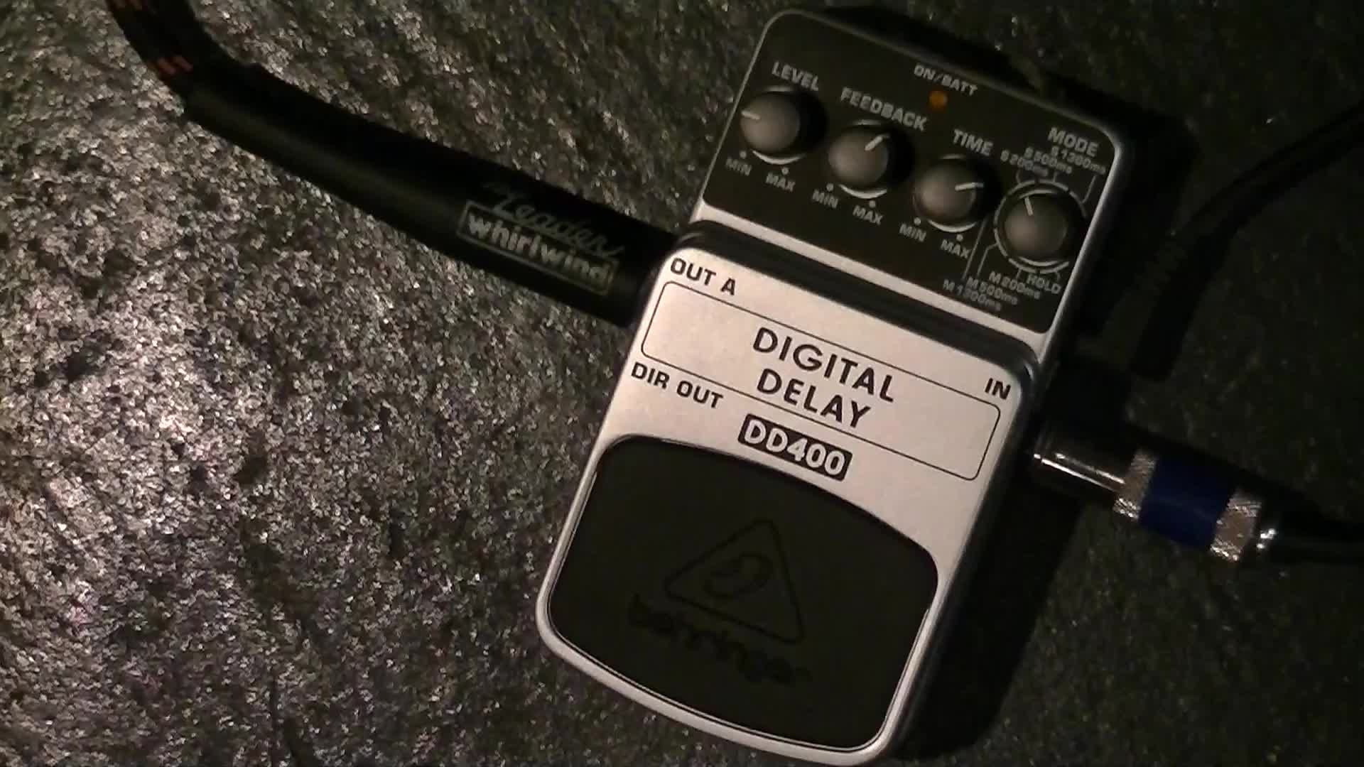Close-up of the Behringer DD400 Digital Delay pedal in its packaging.