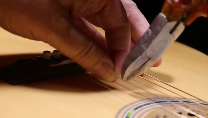 Repeat steps 2-6 for any other broken strings or to replace the entire set ([575.36]).