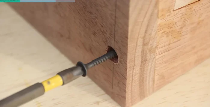 Attach the side pieces with screws; fill, sand, and finish the screw holes.