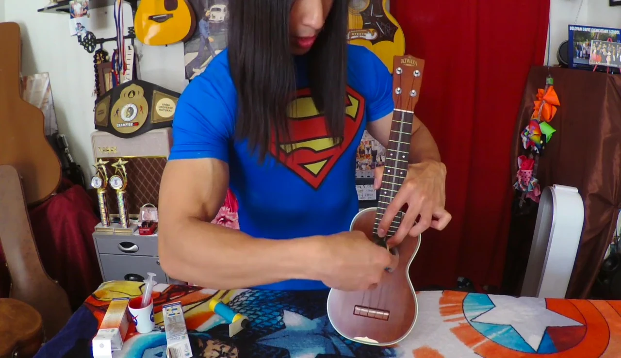 The humidifier being placed into the ukulele soundhole.