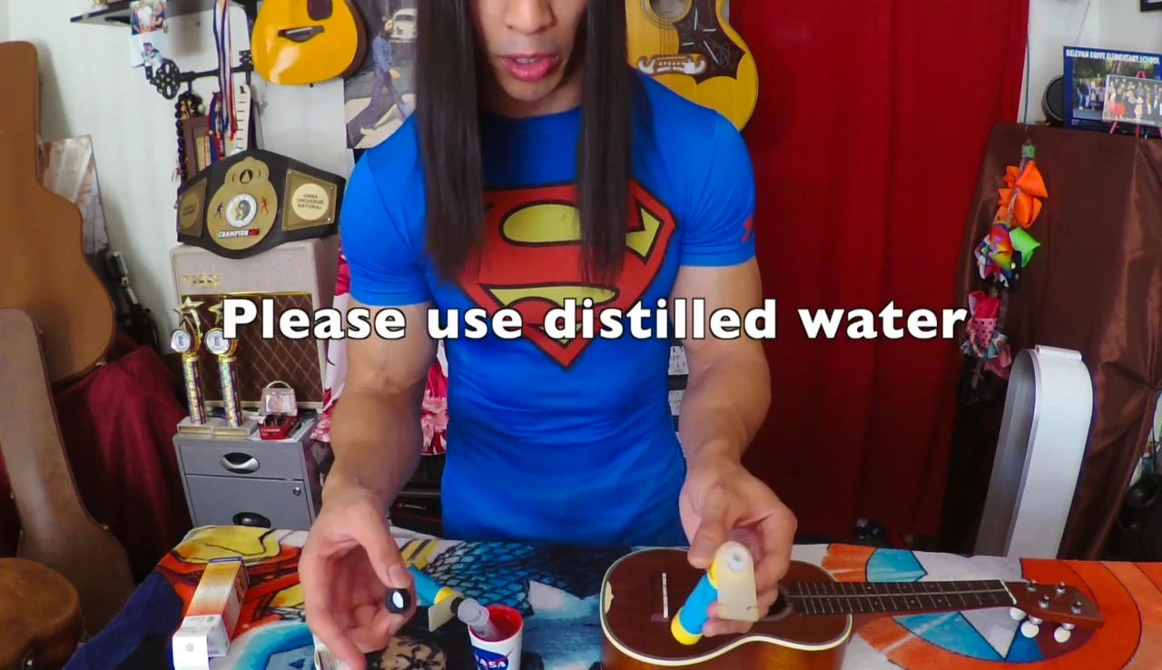 The speaker showing the distilled water for filling.