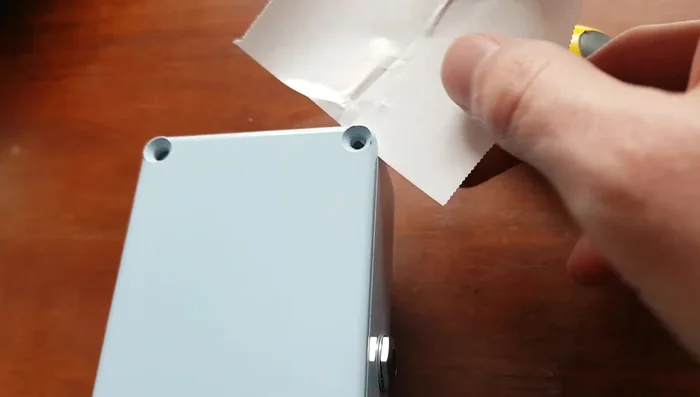 Use the thin object as a lever to pry the battery loose, applying steady and even pressure.