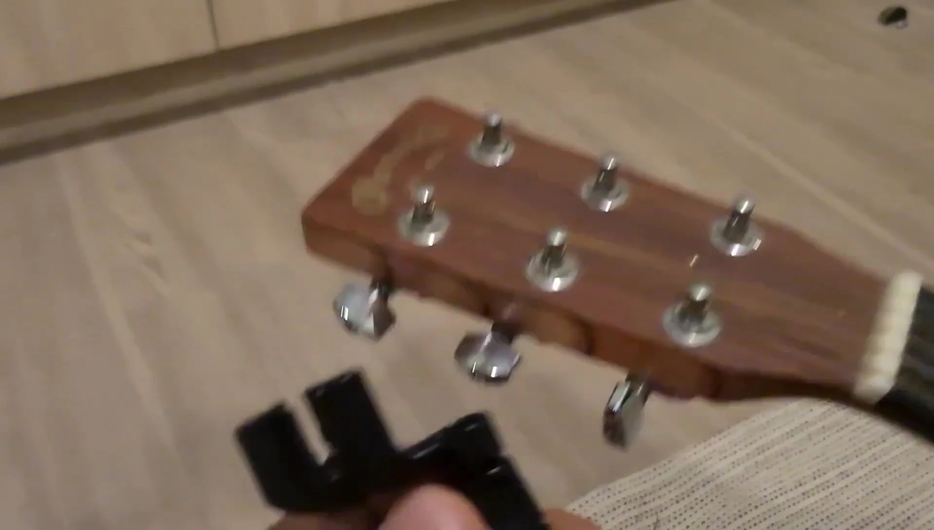 The reviewer holding the D'Addario Pro Winder, conveying satisfaction.