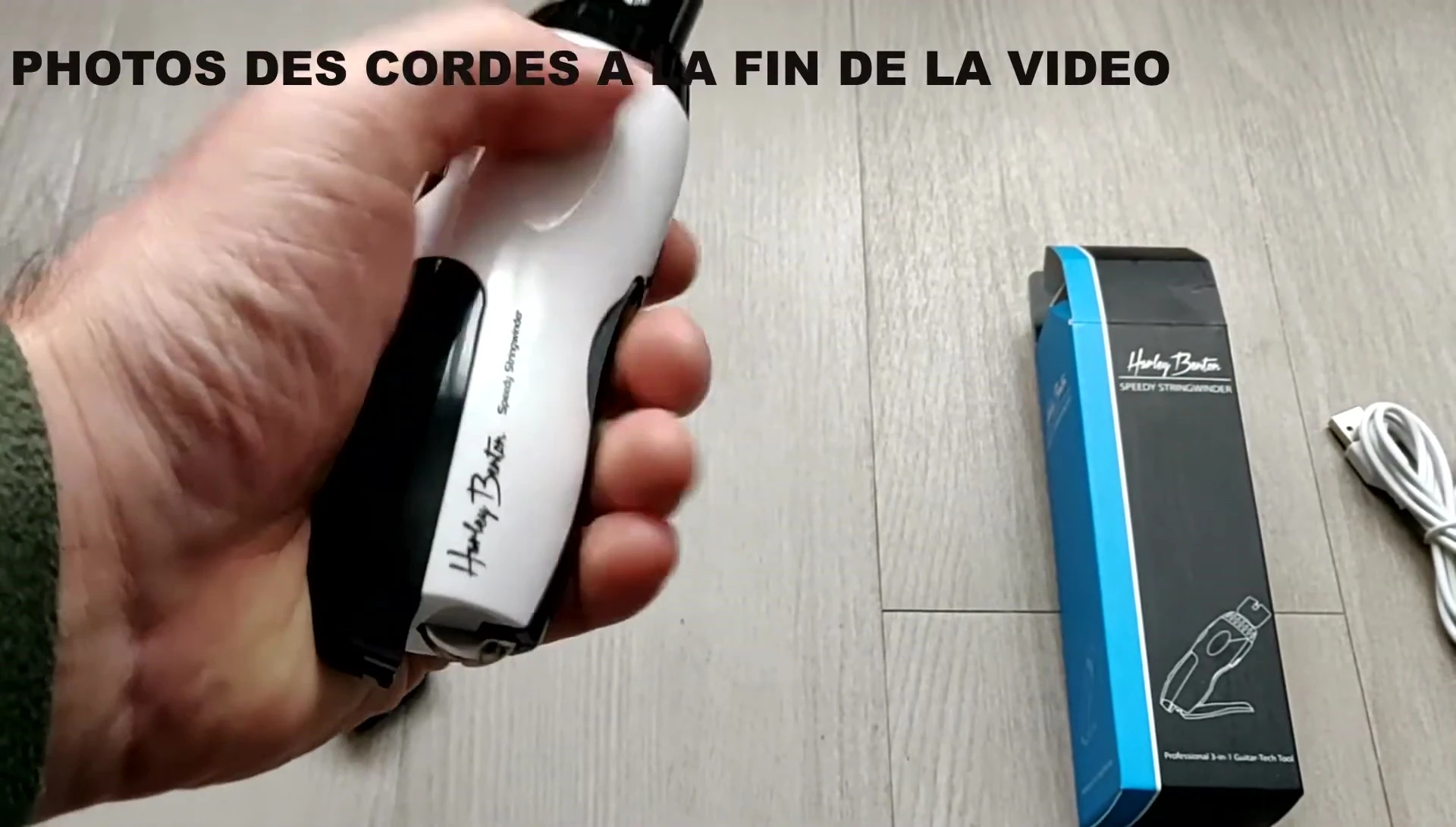 The user demonstrating the comfortable grip of the string winder.