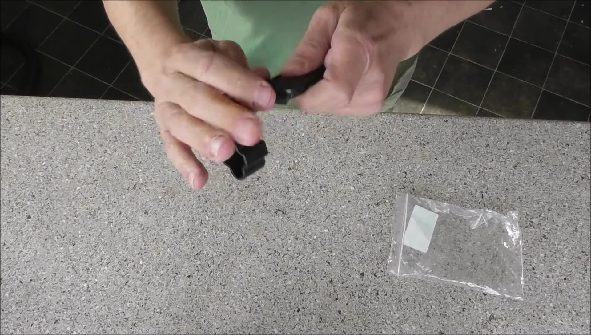 Hands demonstrating difficulty in using the string winder.