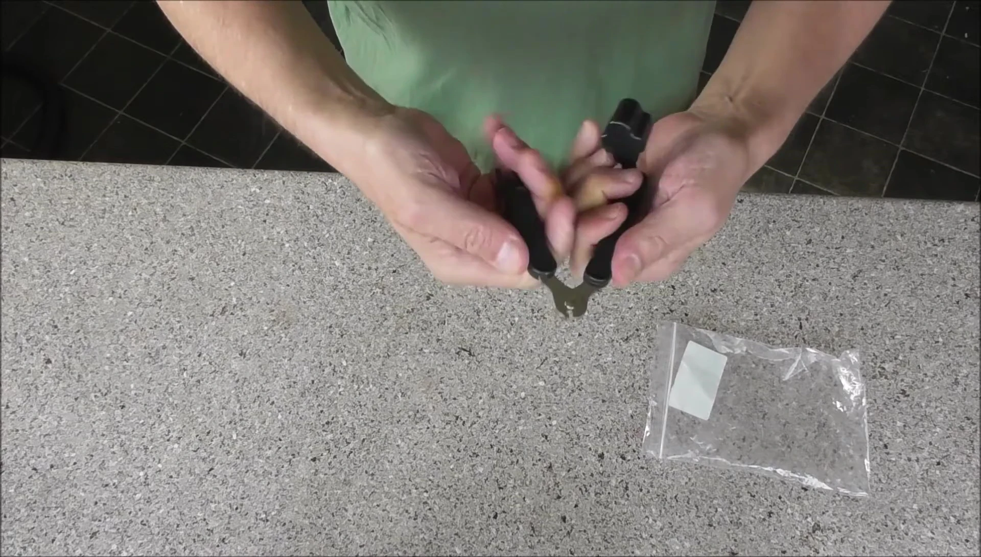 Close-up of the struggle to wind a string using the tool.