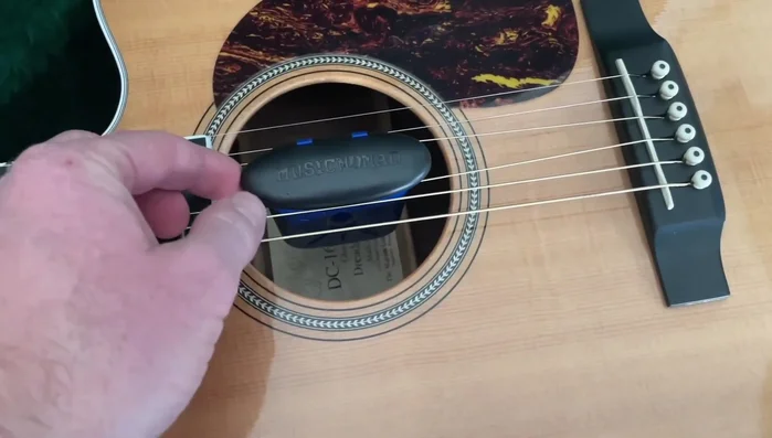 Slide the humidifier into the guitar's sound hole.