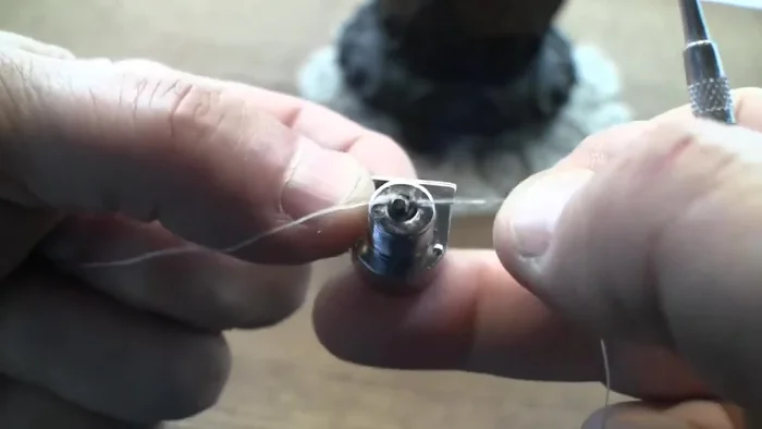 Pull both ends of the floss tight to create tension and gently pull the pin out. This may require incremental pulling as the floss may slip.